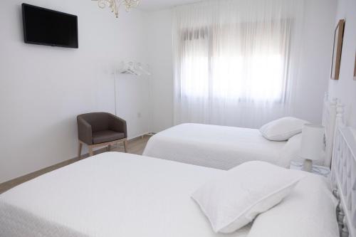 Un ou plusieurs lits dans un hébergement de l'établissement Apartamentos Lua