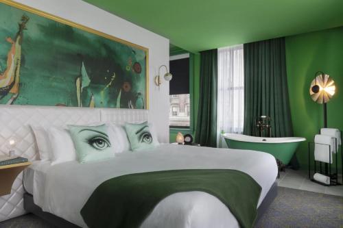 a bedroom with a large bed and a bath tub at Angad Arts Hotel St Louis, Tapestry Collection by Hilton in Saint Louis