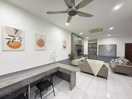 a living room with a couch and a ceiling fan at YOLO5 3BR 12PAX CentralTown Netflix in Kuantan