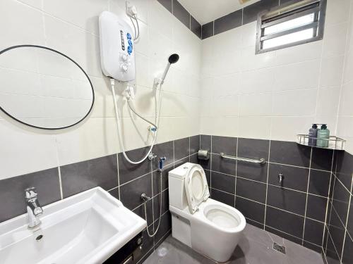 a bathroom with a shower and a toilet and a sink at YOLO5 3BR 12PAX CentralTown Netflix in Kuantan