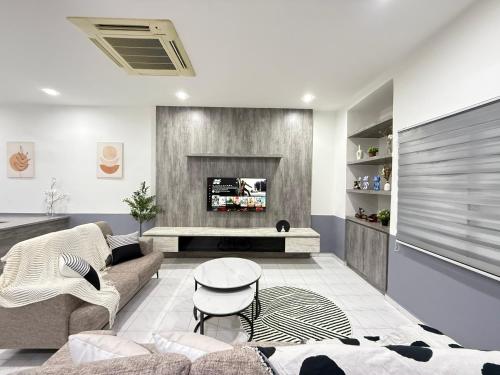 a living room with a couch and a fireplace at YOLO5 3BR 12PAX CentralTown Netflix in Kuantan