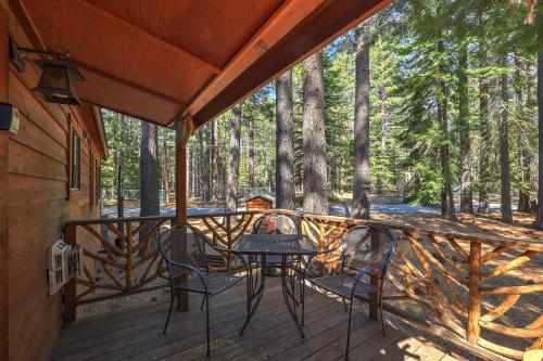a patio with a table and chairs on a deck at The Cozy Cub Cabin 7 Min to Lake in South Lake Tahoe