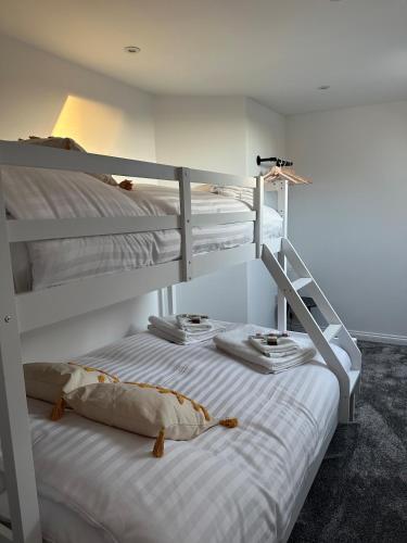 two bunk beds in a room with white walls at Casa Sands in Spittal