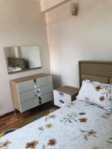 a bedroom with a bed and a mirror at Shanti Dwellingss in Thimi