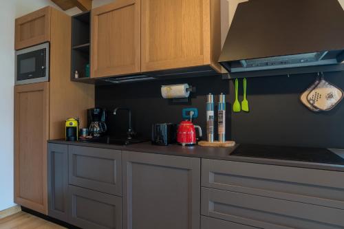 a kitchen with wooden cabinets and a counter top at Casa Titi in Malcesine