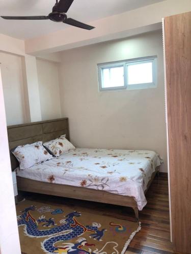 a bedroom with a bed and a ceiling fan at Shanti Dwellingss in Thimi
