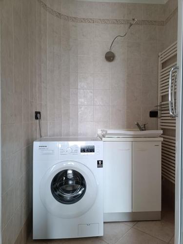 a washing machine in a bathroom with a sink at La Casa del Merlo in Rodello