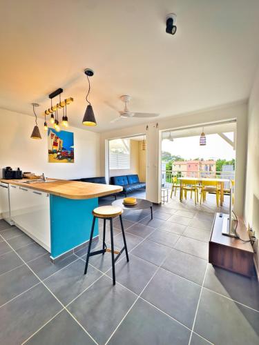 a kitchen and dining room with a table and chairs at A ka titine in Quartiers Anse à lʼÂne