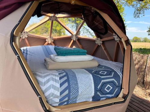 a gazebo with a bed inside of it at Camping La Tourelle in Plémy