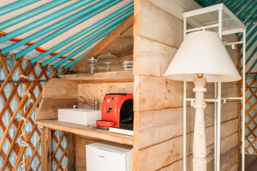 a lamp on a counter in a tiny house at Alpaca country house in Pontedera