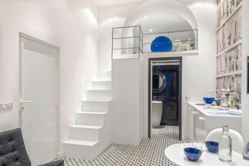a white bathroom with a staircase and a sink at Magnifique Appartement Hypercentre avec Terrasse in Bordeaux