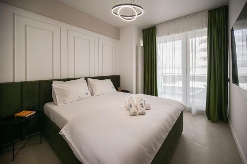 马马亚Rayan Apartment in Odyssey Spa Pool & Fitness-parking的卧室里有一张大床，床上铺着毛巾。