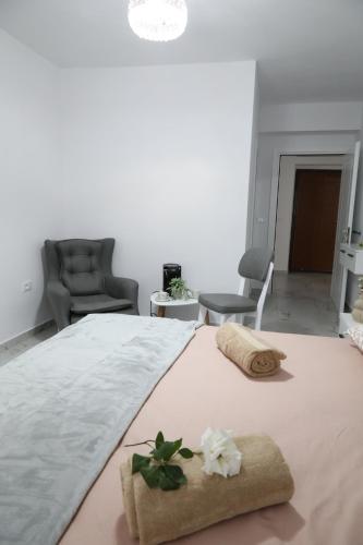 a bedroom with a large bed with towels on it at Rozafa Guest Room Center in Shkodër