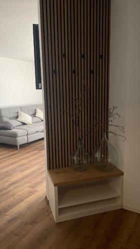 a living room with a couch and a table with vases at Apartments Wally 