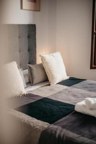 a bed with pillows on it in a room at DreamStay - Oficios Apartamento in Granada