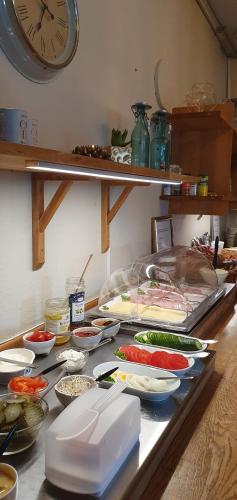 a counter with many different types of food on it at Hotell Briggen i Åhus in Åhus