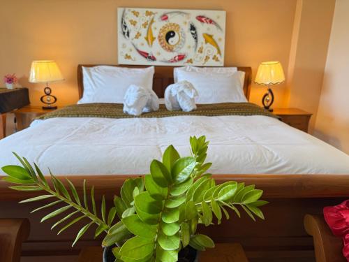 a bedroom with a bed with two towels on it at Laph Kham House in Chiang Mai