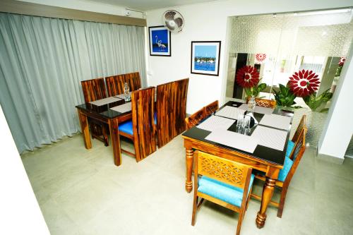 a dining room with a table and chairs at Kaibalya Bliss in Bhubaneshwar