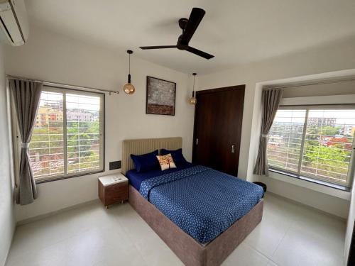 a bedroom with a bed and a ceiling fan at Miracle Stays Nashik-NEW 2BHK close to Sula and Trimbak in Nashik