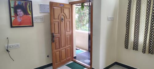 a hallway with a wooden door in a room at Anugrahaa family Roomstay in Tiruchchirāppalli