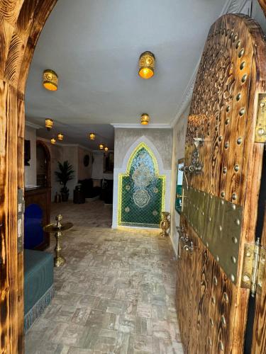 a hallway with a room with a wall with a tile floor at Kasba Green in Tangier