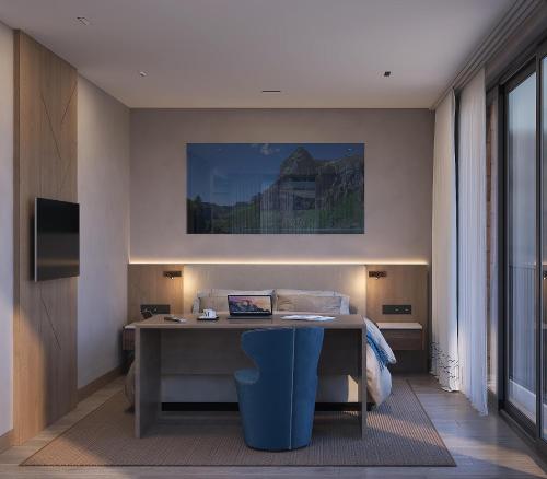 a bedroom with a desk with a bed and a painting at Panoramahotel Braunwald in Braunwald