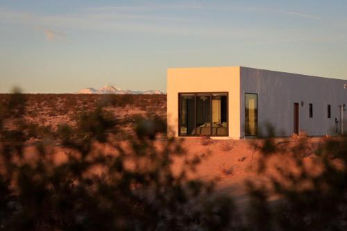 a small building in the middle of the desert at The Milky Way Cabin in Twentynine Palms