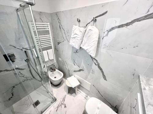a bathroom with a shower and a toilet and a sink at Hotel Boncardo in Finale Ligure