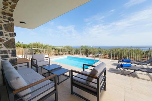 a villa with a swimming pool and a patio at Chryselia Suites- Private Pool in Keratokampos