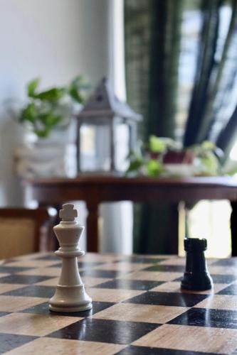 two chess pieces sitting on a chess board at Casa Lux Mundi Lucca in Lucca