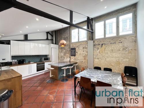 Il comprend une cuisine et une salle à manger avec une table. dans l'établissement Urban Flat 161 - Luxury 4 Bedrooms Apartment, à Paris