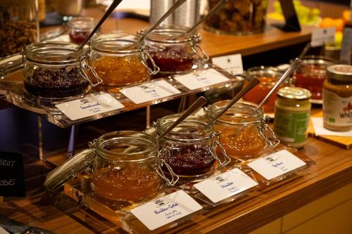 a display of jars of honey on a counter at Romantik Hotel zur Sonne in Badenweiler