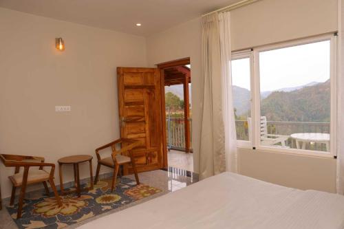 a bedroom with a bed and a window with a view at Whispering Oaks by Happy Himalayan in Rāmgarh