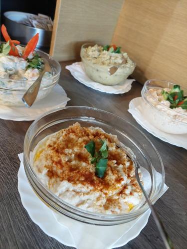 a table topped with bowls of food on plates at New Wolf in Bran