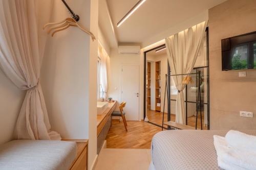 a bedroom with two beds and a bathroom with a sink at Koukaki Cityscape in Athens