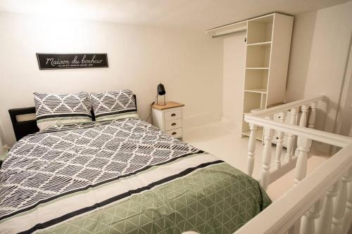 a bedroom with a bed and a book shelf at Le voyageur - Appartement Avec Jacuzzi in Cambrai