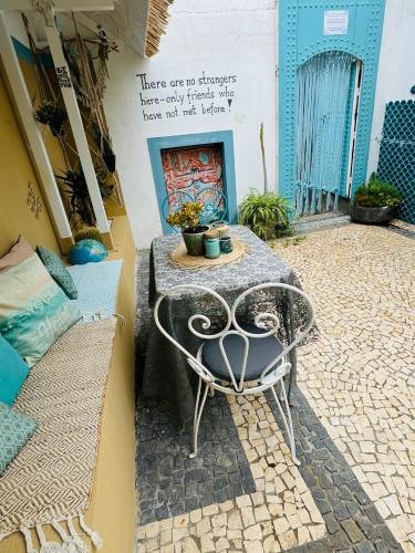 a table and a chair on a patio at CASA BOHO your happy place in Calheta in Calheta