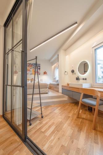 a living room with a table and a bedroom at Koukaki Cityscape in Athens