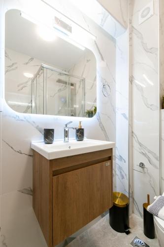 a bathroom with a sink and a mirror at September15 Suites, Lefkada-Episkopos in Nikiana