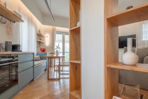 a kitchen with wooden shelves and a dining room at Koukaki Cityscape in Athens