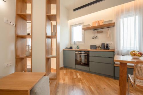 a kitchen with a counter and a table in a room at Koukaki Cityscape in Athens