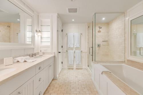 a white bathroom with a tub and a shower at Turtle Bay Villas 307 in Kahuku