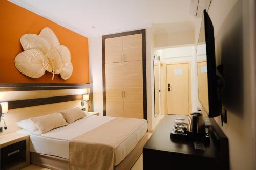 Ένα ή περισσότερα κρεβάτια σε δωμάτιο στο Heritage by Cimen Hotel