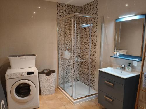 a bathroom with a shower and a washing machine at Quinta do Pomarinho with private pool in Tavira