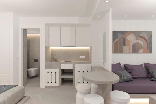 a kitchen and living room with a couch and a table at Likio Studios in Batsi