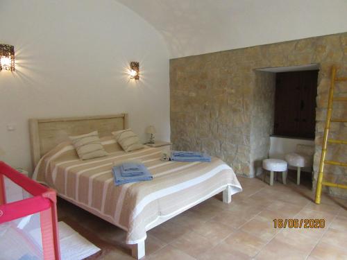 a bedroom with a bed with two towels on it at Quinta do Pomarinho with private pool in Tavira