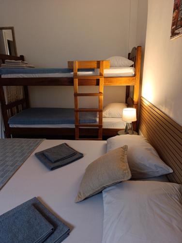 a bedroom with two bunk beds and a bed at Sayohat Apartments in Dobra Voda