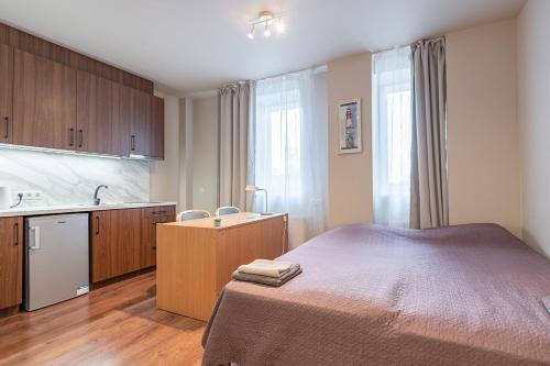 a bedroom with a bed and a sink in it at RVR Smart Apartments Riga with Free Parking and Self Check-in in Rīga