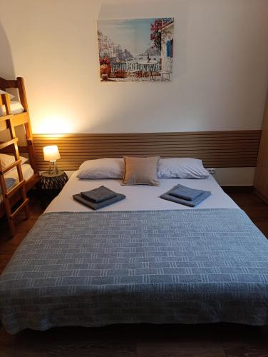 a bedroom with a bed with two towels on it at Sayohat Apartments in Dobra Voda