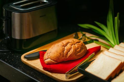 a loaf of bread sitting on a cutting board at Paradise Grand Center Hanoi Hotel in Hanoi